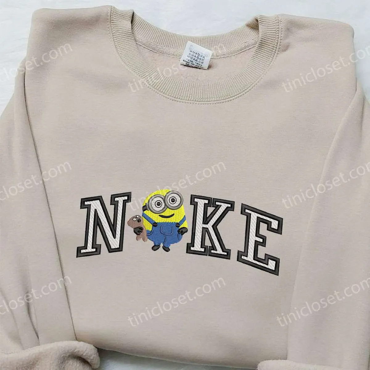 Nike x Minion Bob with Teddy Bear Embroidered Hoodie, Nike Inspired Embroidered Sweatshirt, Cartoon Inspired Embroidered T-shirt Nike x Minion Bob with Teddy Bear Embroidered Hoodie, Nike Inspired Embroidered Sweatshirt, Cartoon Inspired Embroidered T-shirt